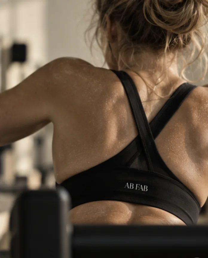 A member in an AB FAB sports top during class
